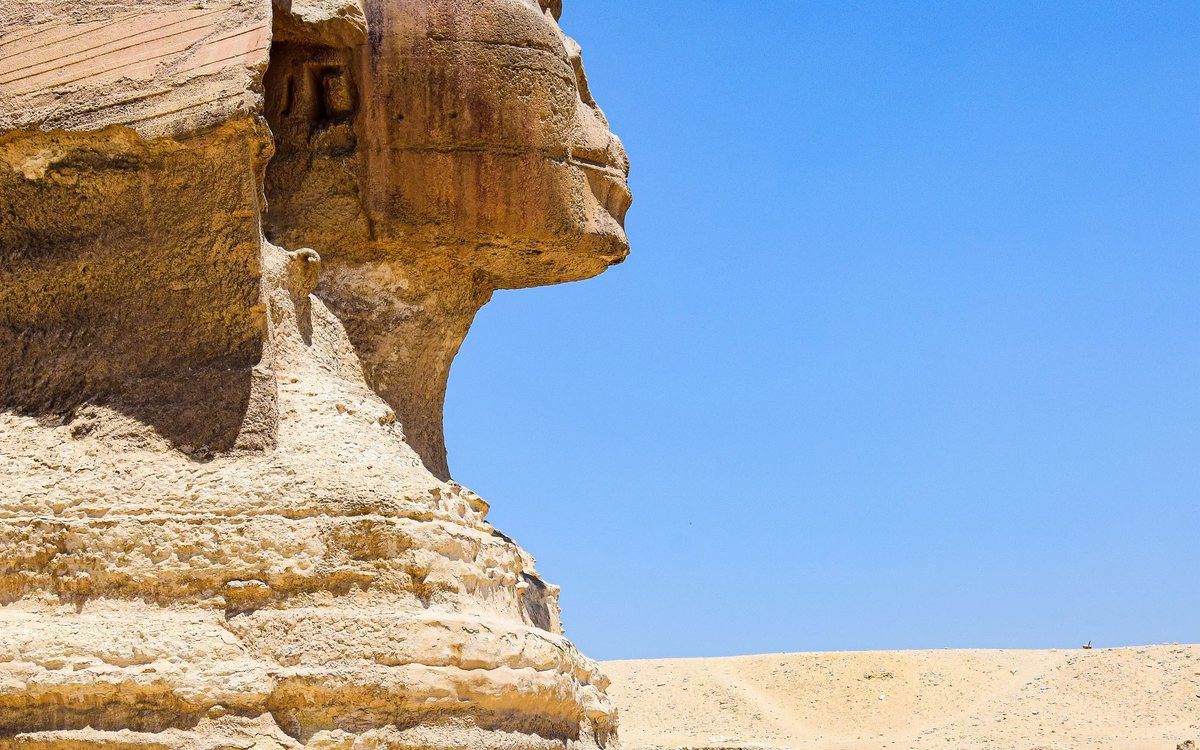 The Great Sphinx of Giza in profile against a clear desert sky